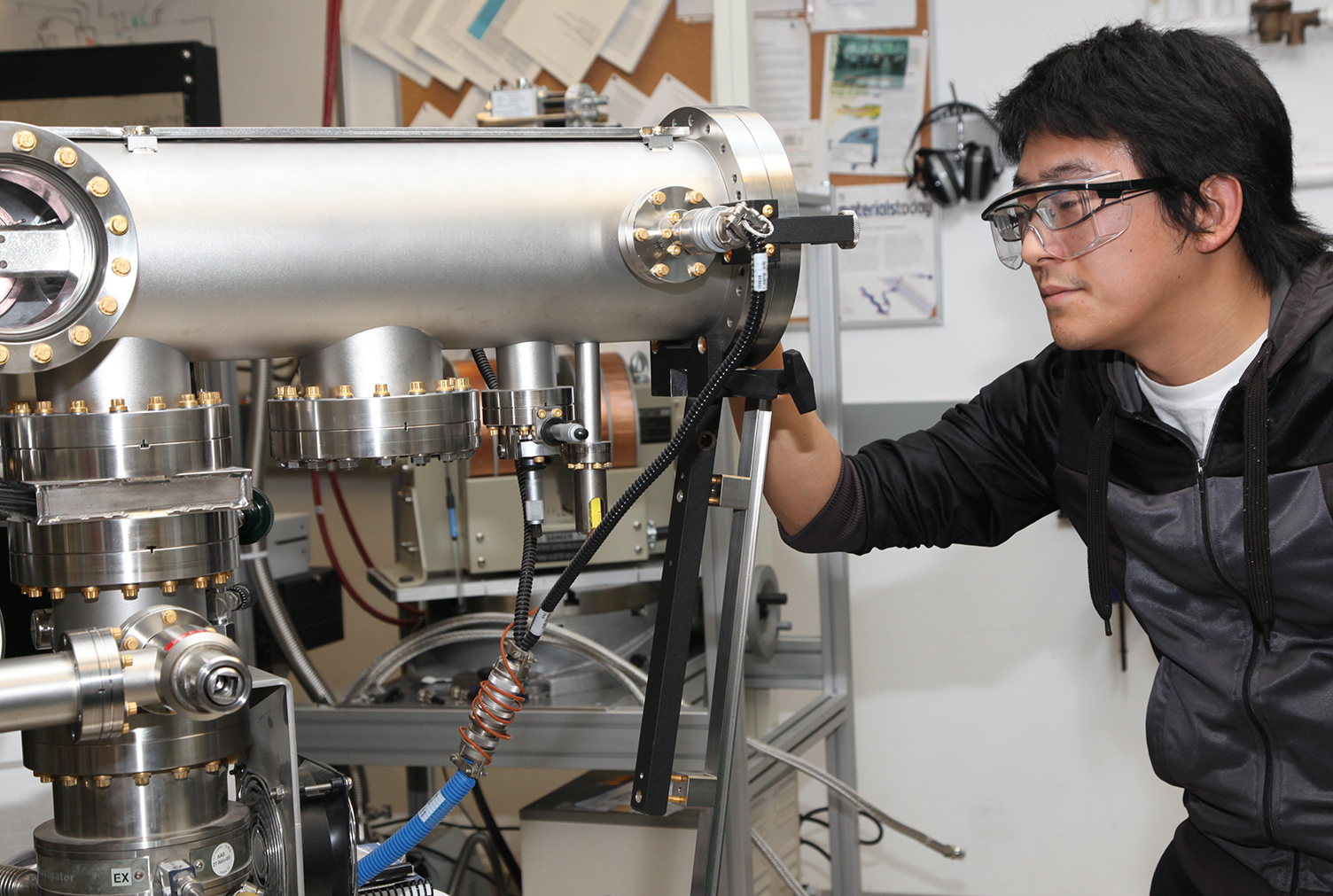 Nanoscale Engineering student looks at tool in a lab on SUNY Poly's Albany campus