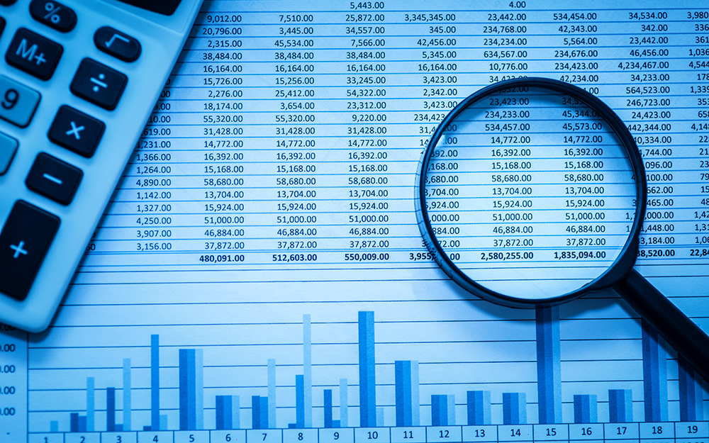 New concentration in Forensic Accounting and Valuation - magnifying glass and spreadsheet