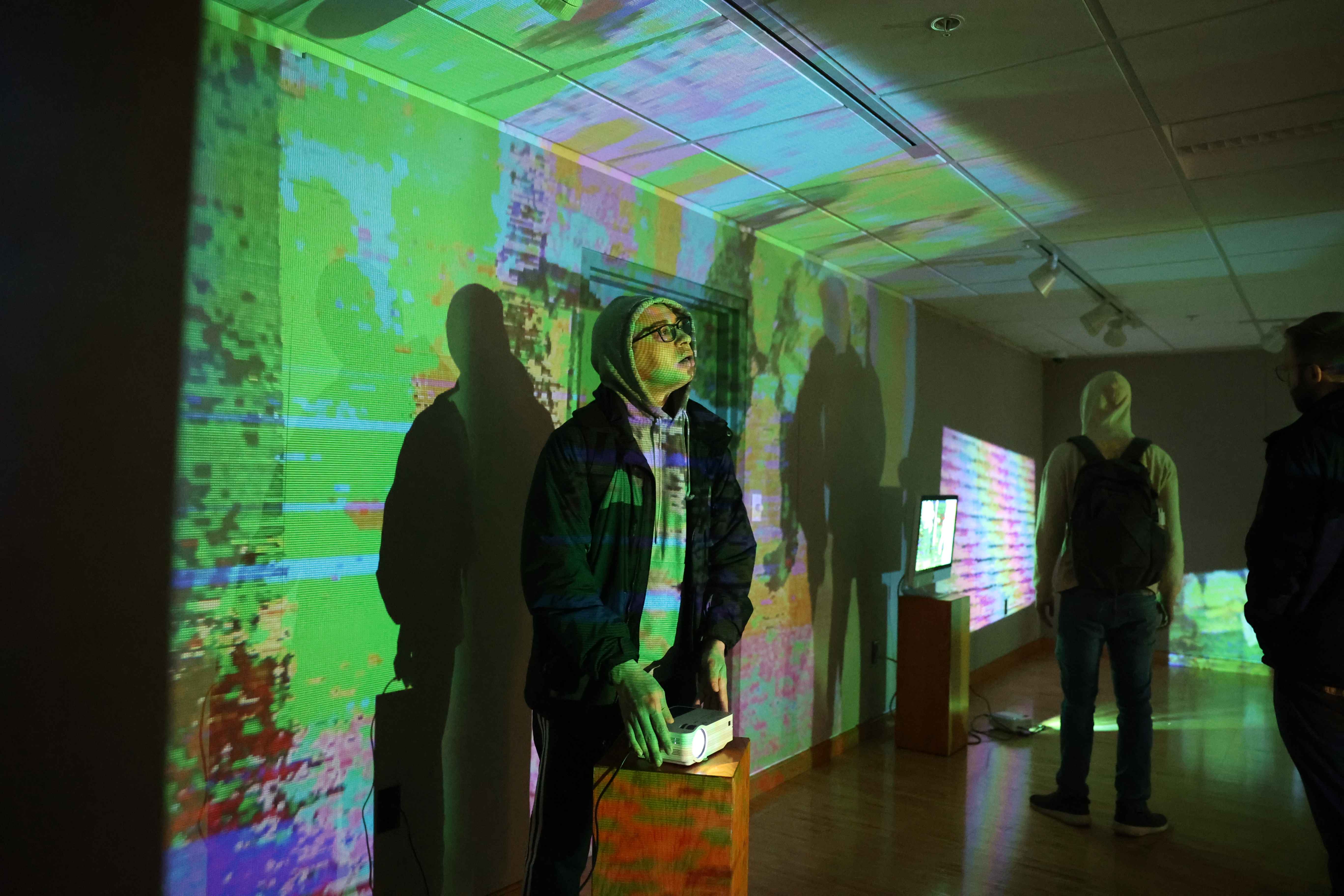 Student participating in interactive digital art exhibit
