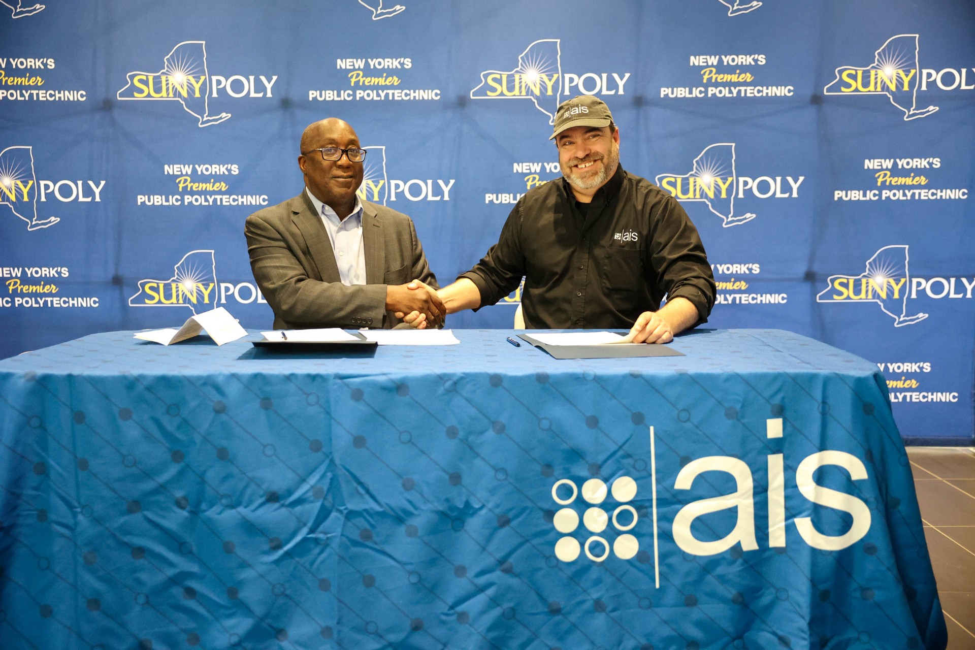 SUNY Poly and AIS representatives signing partnership agreement