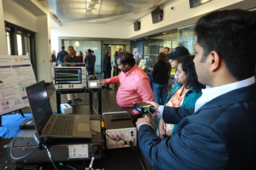Dr. Prinyangshu Sen, center, and Dr. Arjun Singh, far right, of Electrical and Computer Engineering