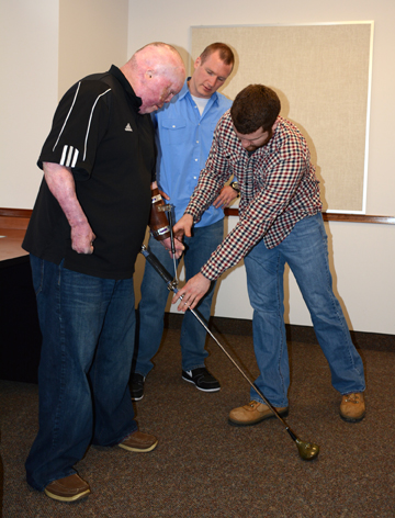 Students assist veteran with adaptive golf club they created