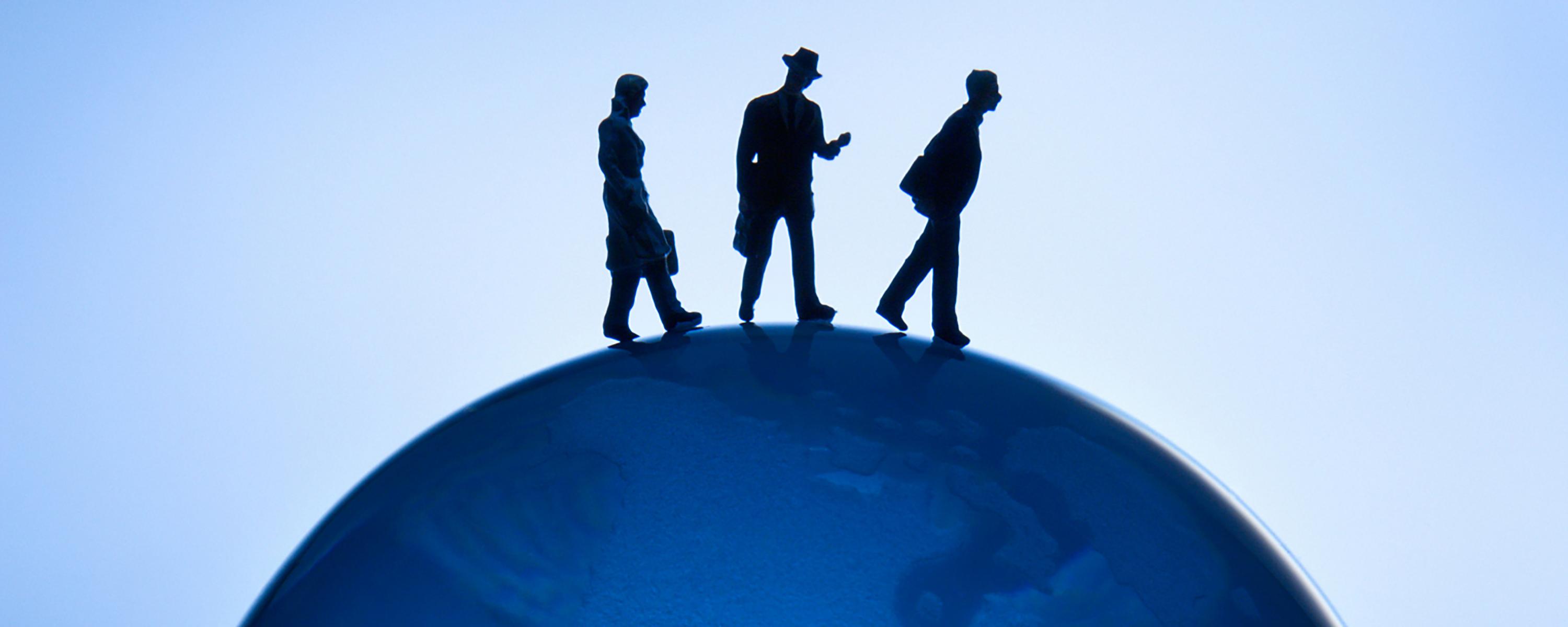 Business Administration - illustrative photo of people walking on globe