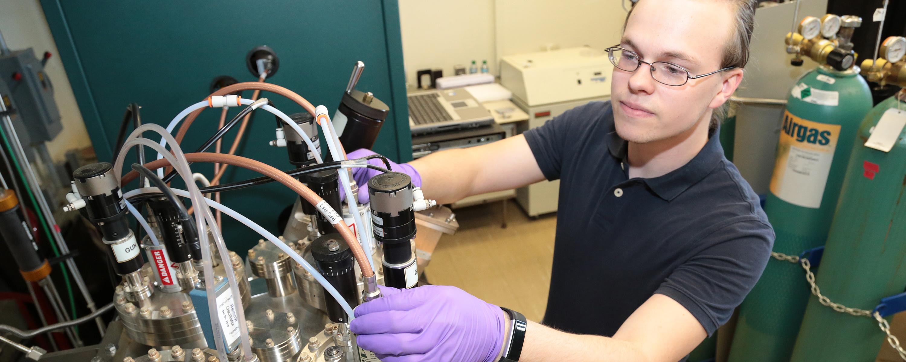 Student working in a lab on the Albany campus