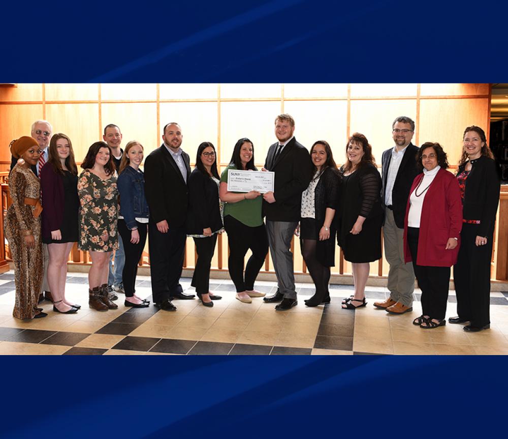 Members of the Psychology and Sociology Club present $10,000 check to Kids Oneida