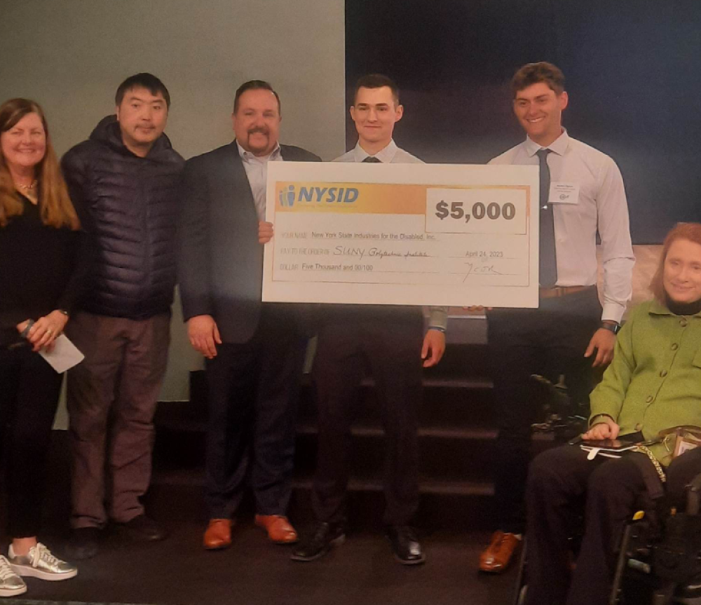 SUNY Poly students Luke Handerhan (L-center) and Zachary Byrum (R-center) with winning check