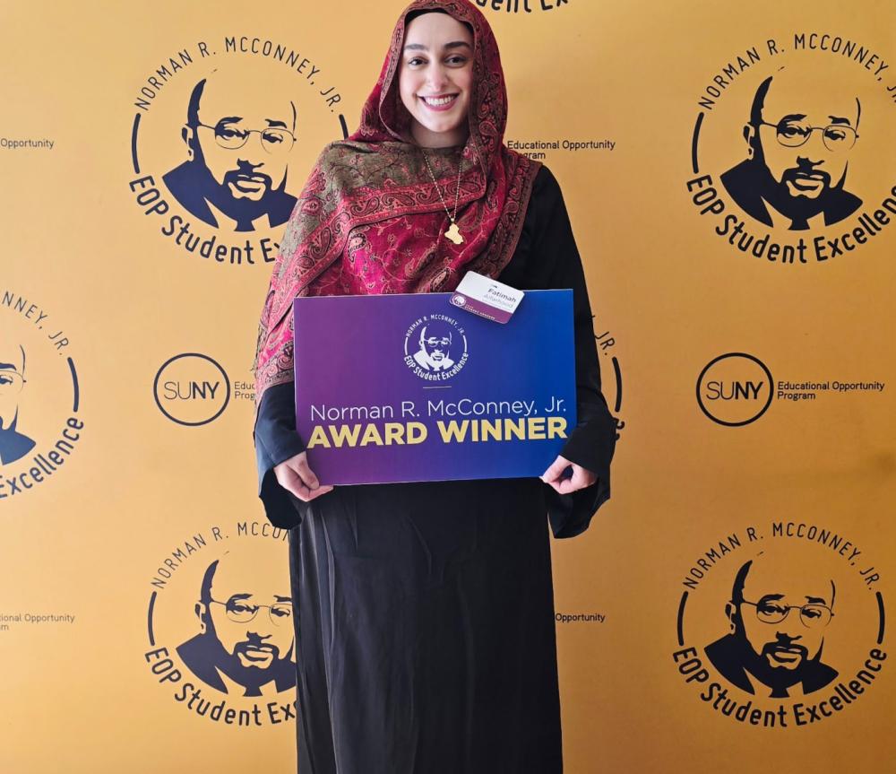SUNY Poly's Fatimah Alfarhood holding her Norman R. McConney Jr Award