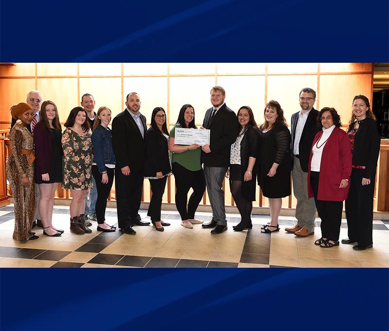 Members of the Psychology and Sociology Club present $10,000 check to Kids Oneida