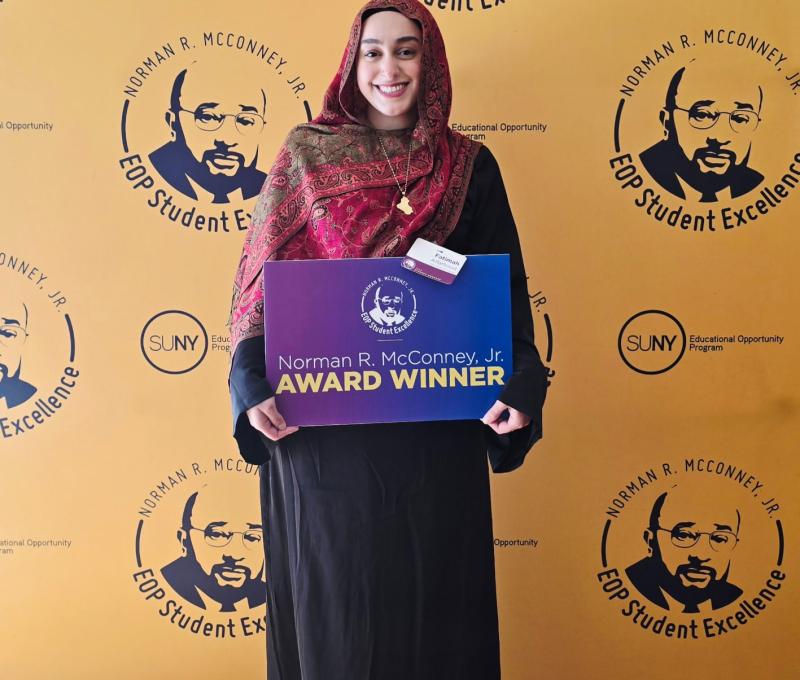SUNY Poly's Fatimah Alfarhood holding her Norman R. McConney Jr Award